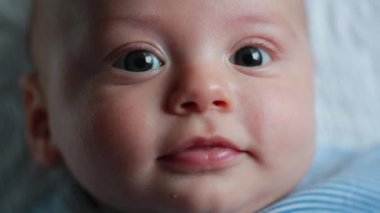 Sweet baby newborn in first month of life closeup face