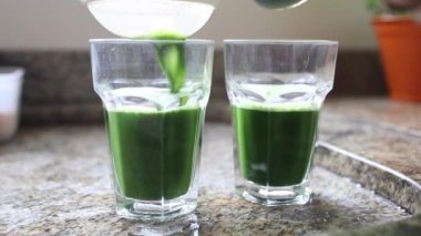 Serving green juice detox home-made, kale and vegetable juice