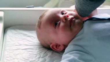 Mother lifting crying baby for consolation