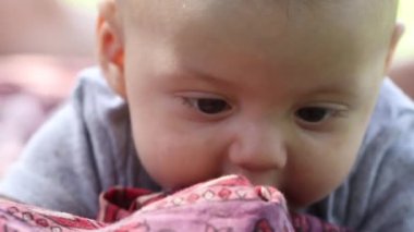 three month old baby on the ground being curious struggling to learn, showing effort