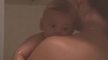 Mother bathing baby in shower mom holding infant