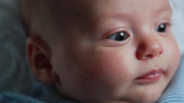 Beautiful baby newborn closeup face smiling and feeling happy