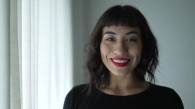 Happy person with Native American traits smiling. Portrait of young South American young woman of Indigenous descent