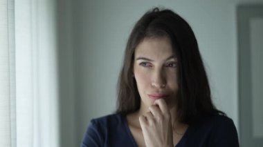 Confused young woman in doubt in dilemma