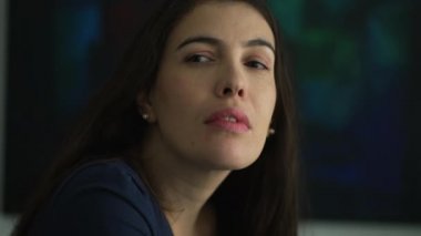 One thoughtful woman portrait face with serious expression looks at camera