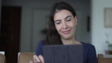 CLoseup woman face looking at tablet screen smiling. Portrait person reading content online with modern digital device