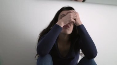 One fearful person overwhelmed with emotional problems. Ashamed woman remembering traumatic event