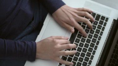 Closeup female hands typing on laptop computer keyboard