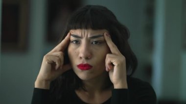 One concentrated hispanic latin girl closeup face introspective emotion. A young South American person with regret