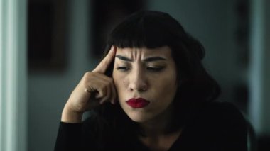 Concerned young woman suffering feeling frustrated closeup face portrait. One pensive hispanic girl