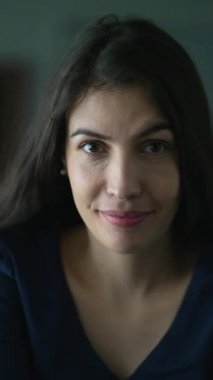 Portrait of a woman in 30s in vertical video. Confident Person looking at camera