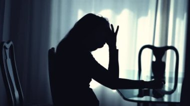 Worried pensive woman suffering at home remembering trauma. Person with mental illness in depression