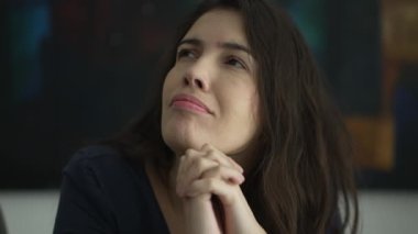 Woman with preoccupied expression closing eyes with regret. Person remembering past