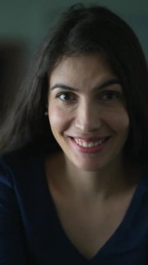 Woman smiling at camera portrait in vertical video