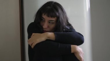 Preoccupied anxious young woman. One South American hispanic girl being fearful and suffering