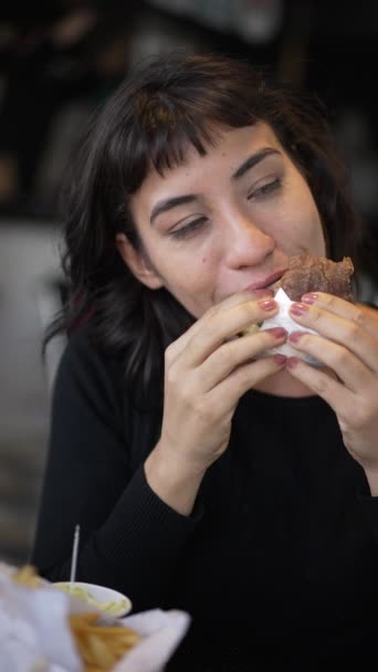 Young Woman Eating Burger Portrait Face Vertical Video Happy Girl — Video Stock