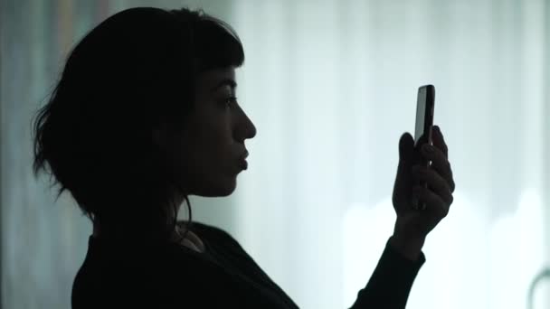 Silhouette One Young Woman Looking Smartphone Device Girl Scrolling Media — Stockvideo