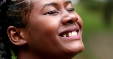 African woman spontaneous laugh and smile, real and authentic reaction