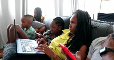 Real life family using technology at home sofa