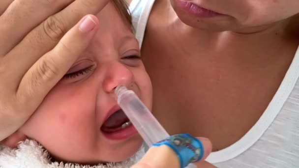 Mother Removing Baby Mucus Toddler Congested Nose — Stok video
