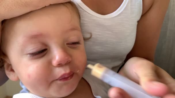 Mother Feeding Medicine Baby Toddler Syringe Mouth — Stockvideo