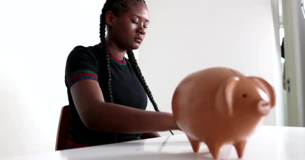 Black Girl Saving Money Putting Coins Piggy Bank — Vídeo de Stock