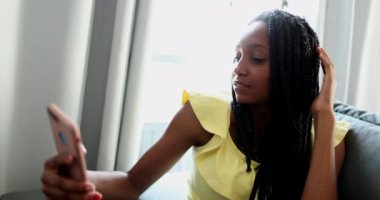 Teen black girl taking selfie with smartphone