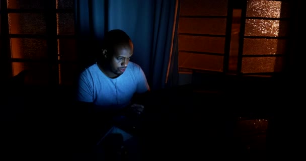 African Man Browsing Internet Late Night Pitch Dark — ストック動画