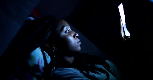 Black African Teen Girl Lying Bed Looking Cellphone Screen Night — Stok video