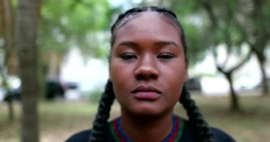 Young African black woman walking forwards towards camera, portrait mixed race girl