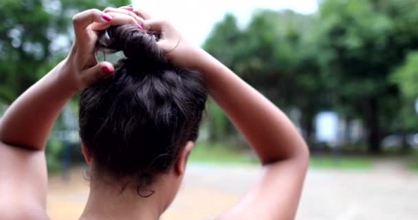 Woman Tying Hair Back Girl Adjusts Hair Outdoors — Stock Video
