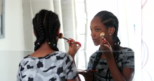 Teenager Black Girl Applying Makeup Brush Looking Mirror — стоковое видео