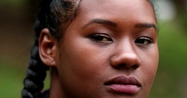 Confident young black woman looking at camera. Portrait of mixed race girl in 20s