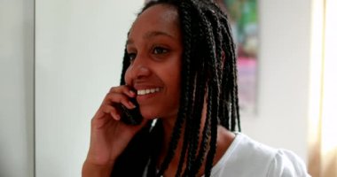Mixed race girl speaking on smartphone device. Teenager answering call