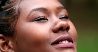 Black woman face looking up to sky feeling HAPPY and smiling