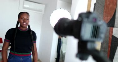 Black female vlogger speaking to camera. African mixed race girl talking to media channel