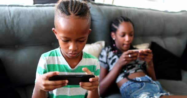 African Siblings Using Cellphone Home Black Ethnicity Children Watching Video — Stockvideo