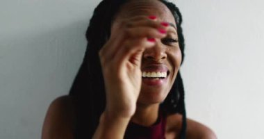 Happy African woman spontaneous laugh and smile