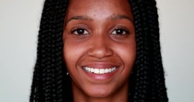 Genç siyahi kadın kameraya gülümsüyor, Afro-Amerikan kız portresi yakından gülümsüyor.