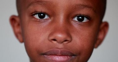 Karışık ırk çocuğu yakın plan yüz portresi. Afrikalı Amerikalı çocuk kameraya bakıyor.