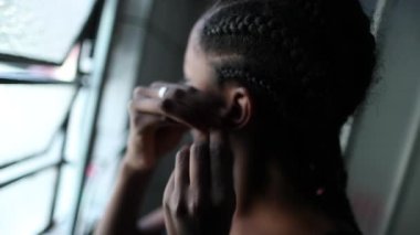 African teen girl putting earrings