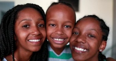 African children smiling at camera. Black ethnicity little boy and teen sisters