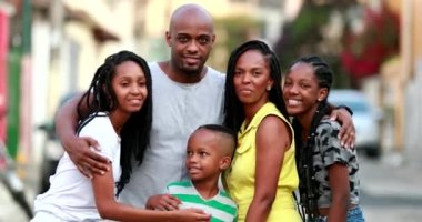 Beautiful black family embrace. Loving father hugging wife and children. African ethnicity