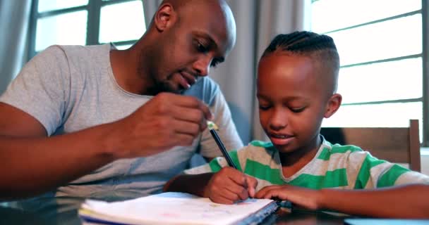 Father Helping Son Homework Home African Black Dad Mentoring Little — Stockvideo
