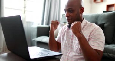 Happy black African man celebrating success, good news