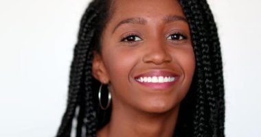 Pretty mixed race African girl smiling at camera. Young teen black woman