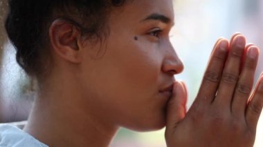 Grateful young woman smiling outside
