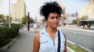 Young woman commuting from work walking in city