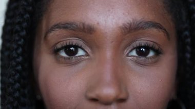 Black African teen girl close-up eyes looking at camera