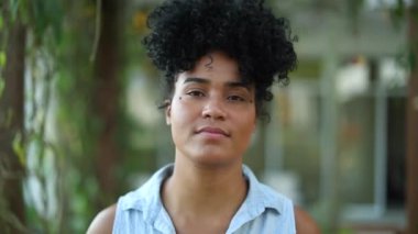 Proud young African American woman walking forward to camera